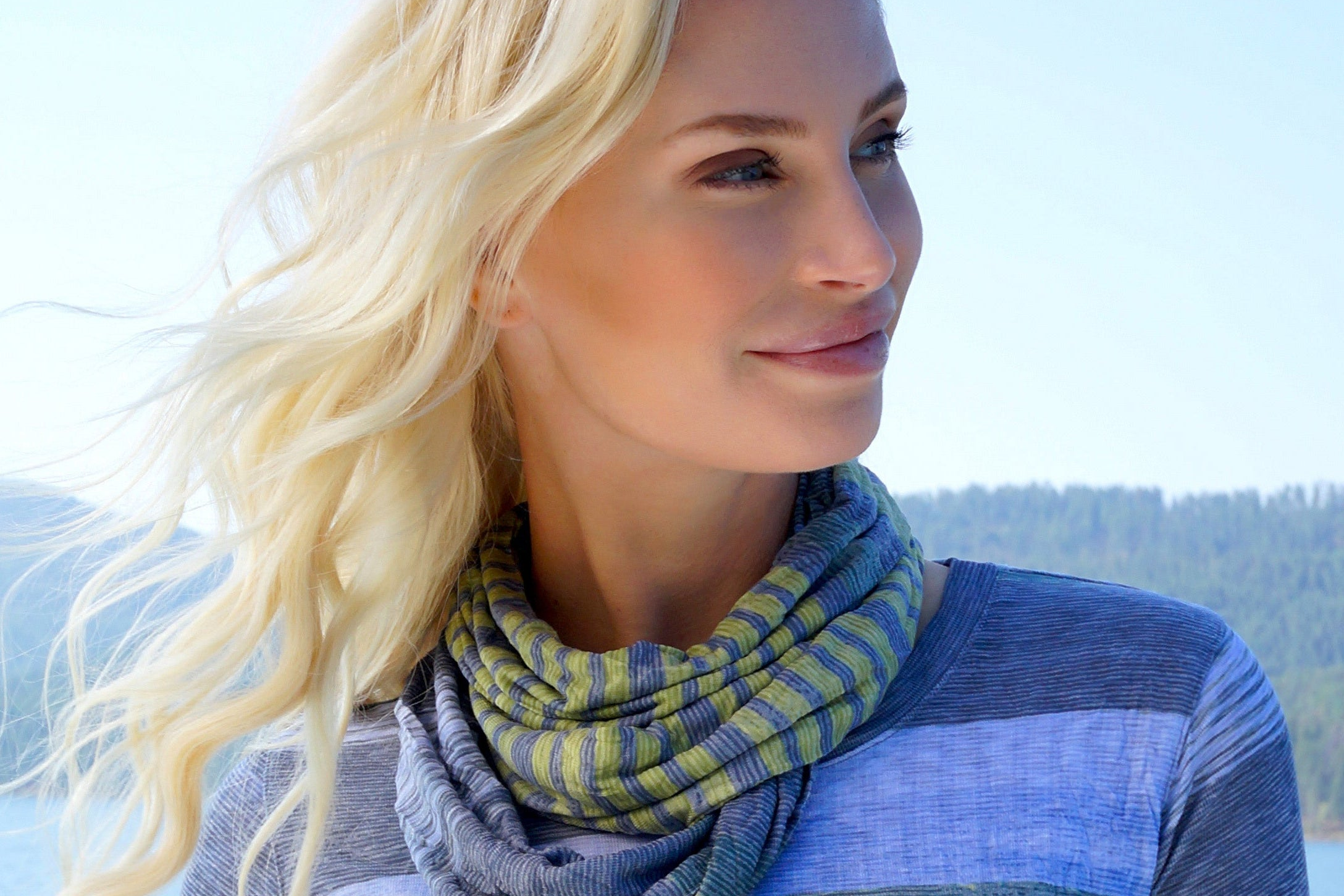 Woman wearing a colorful scarf with a scenic background